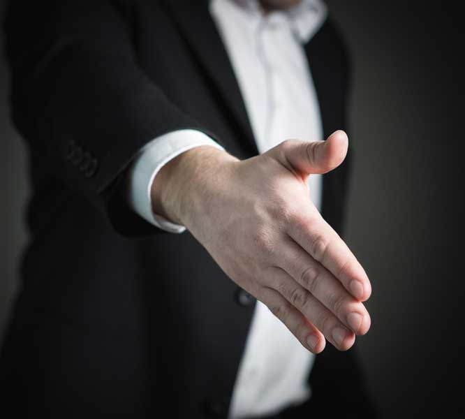 A businessman reaching out for a handshake