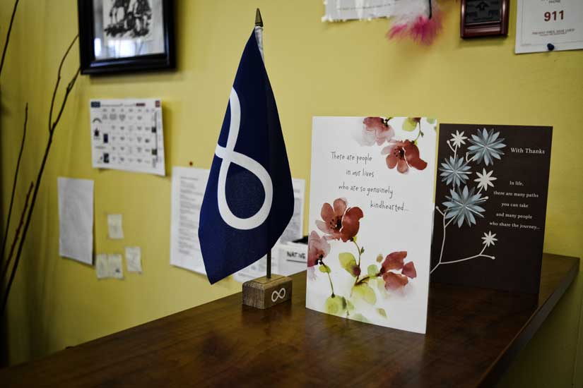 Metis Nation flag beside cards with quotes of inspiration