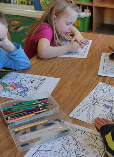 Young children coloring together on a table