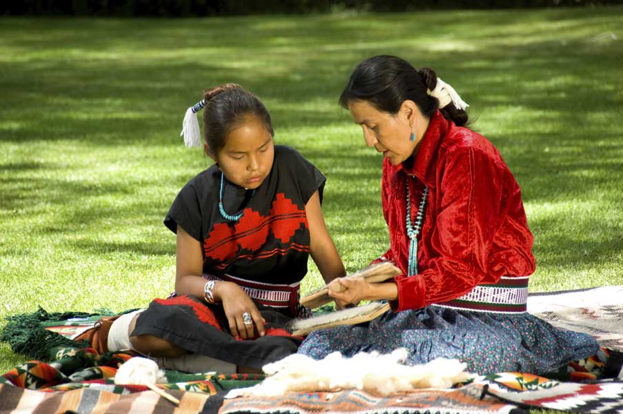An Aboriginal Elder instructing a young child